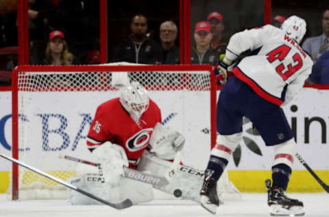 RALEIGH, NC – MARCH 28: Tom Wilson #43 of the Washington Capitals fires a shot on goal and Curtis McElhinney #35 of the Carolina Hurricanes makes the save during an NHL game on March 28, 2019 at PNC Arena in Raleigh, North Carolina. (Photo by Gregg Forwerck/NHLI via Getty Images)