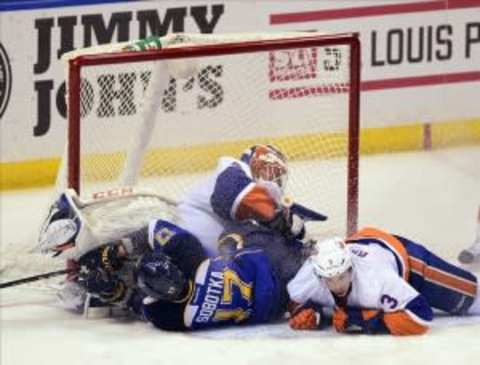 Dec 5, 2013; St. Louis, MO, USA; St. Louis Blues center Vladimir Sobotka (17) is checked into New York Islanders goalie Anders Nilsson (45) by Islanders defenseman Travis Hamonic (3) during the third period at the Scottrade Center. The Blues defeated the Islanders 5-1. Mandatory Credit: Jeff Curry-USA TODAY Sports