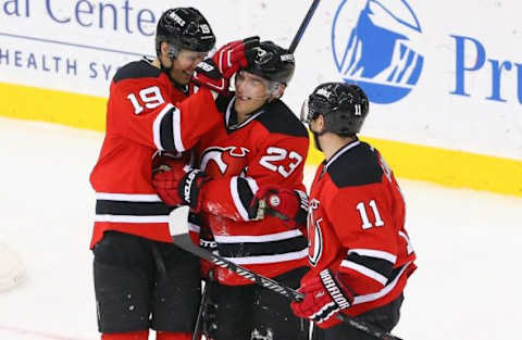 NHL Team Name Origins: New Jersey Devils right wing Stephen Gionta (11) and center Travis Zajac (19) congratulate left wing Mike Cammalleri (23) on his goal during the third period at Prudential Center. The Devils defeated the Predators 3-1. Mandatory Credit: Ed Mulholland-USA TODAY Sports