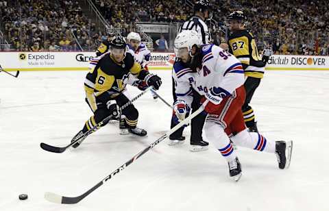 May 9, 2022; Pittsburgh, Pennsylvania, USA; New York Rangers center Mika Zibanejad (93) chases the puck ahead of Pittsburgh Penguins defenseman John Marino (6) during the third period in game four of the first round of the 2022 Stanley Cup Playoffs at PPG Paints Arena. The Penguins won 7-2. Mandatory Credit: Charles LeClaire-USA TODAY Sports