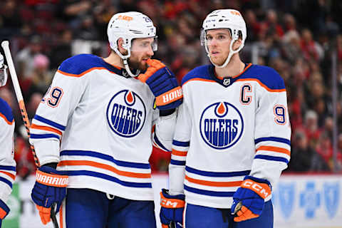 Nov 30, 2022; Chicago, Illinois, USA; Edmonton Oilers forward Leon Draisaitl (29) and forward Connor McDavid (97) talk before a face off against the Chicago Blackhawks at United Center. Mandatory Credit: Jamie Sabau-USA TODAY Sports