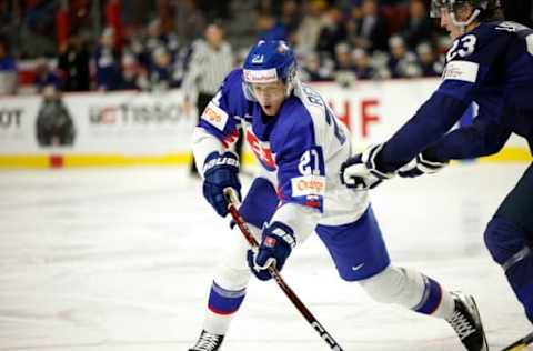 MONCTON, NB – DECEMBER 27: Peter Repcik # 21 of team Slovakia takes a shot on net with Kalle Vaisanen #23 of Team Finland checking him during the third period during the 2023 IIHF World Junior Championship at Avenir Centre on December 27, 2022, in Moncton, Canada. (Photo by Dale Preston/Getty Images)