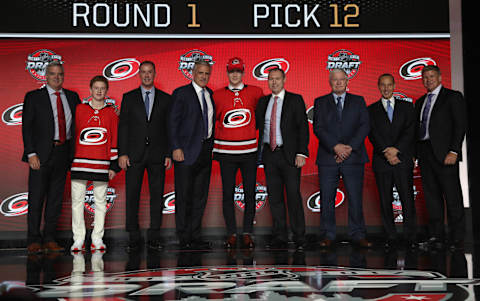 CHICAGO, IL – JUNE 23: (L-R) Assistant general manager Mike Velluci, draft runner, pro scout/advisor Joe Nieuwendyk, general manager Ron Francis, 12th overall pick Martin Necas, head European scout Robert Kron, director of amateur scouting Tony MacDonald, assistant general manager Ricky Olczyk and head coach Bill Peters of the Carolina Hurricanes pose for a photo onstage during Round One of the 2017 NHL Draft at United Center on June 23, 2017 in Chicago, Illinois. (Photo by Dave Sandford/NHLI via Getty Images)