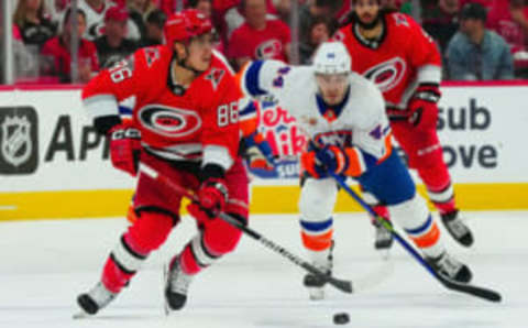 Apr 19, 2023; Raleigh, North Carolina, USA; Carolina Hurricanes left wing Teuvo Teravainen (86) skates with the puck past New York Islanders center Jean-Gabriel Pageau (44) during the first period in game two of the first round of the 2023 Stanley Cup Playoffs at PNC Arena. Mandatory Credit: James Guillory-USA TODAY Sports