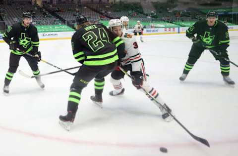 DALLAS, TEXAS – FEBRUARY 07: Brandon Hagel #38 of the Chicago Blackhawks skates the puck against Roope Hintz #24 of the Dallas Stars the third period at American Airlines Center on February 07, 2021 in Dallas, Texas. (Photo by Ronald Martinez/Getty Images)