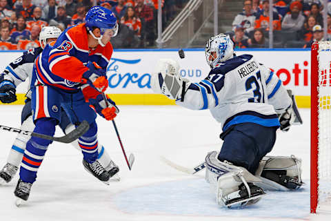 Oct 21, 2023; Edmonton, Alberta, CAN; Winnipeg Jets goaltender Connor Hellebuyck (37) makes a save on Edmonton Oilers forward Mattias Janmark (13) during the third period at Rogers Place. Mandatory Credit: Perry Nelson-USA TODAY Sports