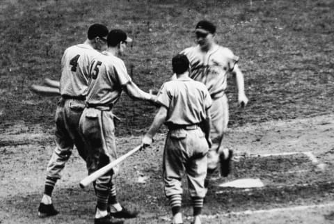 NEW YORK – OCTOBER 5: Whitey Kurowski #1 (1918 – 1999) of the St. Louis Cardinals runs across home plate after hitting a home run as his teammates Marty Marion #4 and Walker Cooper #15 congratulate him during game five of the 1942 World Series against the New York Yankees at Yankee Stadium, in the Bronx, New York on October 5, 1942. The Cardinals won game five 4-2 and wrapped up the series. (Photo by Hulton Archive/Getty Images)