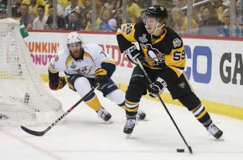 May 29, 2017; Pittsburgh, PA, USA; Pittsburgh Penguins center Jake Guentzel (59) with the puck against Nashville Predators defenseman Yannick Weber (7) during the third period in game one of the 2017 Stanley Cup Final at PPG PAINTS Arena. Mandatory Credit: Charles LeClaire-USA TODAY Sports