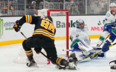 Nov 28, 2021; Boston, Massachusetts, USA; Boston Bruins right wing David Pastrnak (88) scores a goal on Vancouver Canucks goalie Jaroslav Halak (41) during the third period at TD Garden. Mandatory Credit: Gregory Fisher-USA TODAY Sports