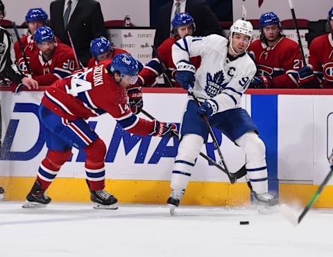 MONTREAL, QC – FEBRUARY 10: John Tavares #91 of the Toronto Maple Leafs plays the puck past Nick Suzuki #14 of the Montreal Canadiens during the third period at the Bell Centre on February 10, 2021 in Montreal, Canada. The Toronto Maple Leafs defeated the Montreal Canadiens 4-2.  (Photo by Minas Panagiotakis/Getty Images)