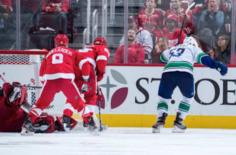 DETROIT, MI – OCTOBER 22: Bo Horvat #53 of the Vancouver Canucks scores a third period goal past goaltender Jimmy Howard #35, Justin Abdelkader #8 and Trevor Daley #83 of the Detroit Red Wings during an NHL game at Little Caesars Arena on October 22, 2019 in Detroit, Michigan. (Photo by Dave Reginek/NHLI via Getty Images)