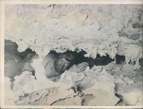 Floyd Collins navigates a tight spot in Crystal Cave.