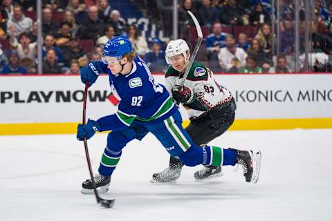 Apr 14, 2022; Vancouver, British Columbia, CAN; Arizona Coyotes defemseman Vladislav Kolyachonok (92) looks on as Vancouver Canucks forward Vasily Podkolzin (92) shoots in the third period at Rogers Arena. Canucks won 7-1. Mandatory Credit: Bob Frid-USA TODAY Sports