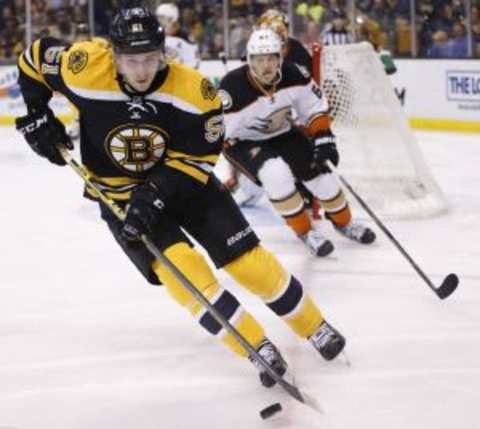 Mar 26, 2015; Boston, MA, USA; Boston Bruins center Ryan Spooner (51) controls the puck during the third period against the Anaheim Ducks at TD Banknorth Garden. The Anaheim Ducks won 3-2 in overtime. Mandatory Credit: Greg M. Cooper-USA TODAY Sports