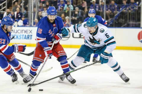 Dec 3, 2023; New York, New York, USA; New York Rangers center Vincent Trocheck (16) and San Jose Sharks defenseman Matt Benning (5) battle for control of the puck in the second period at Madison Square Garden. Mandatory Credit: Wendell Cruz-USA TODAY Sports