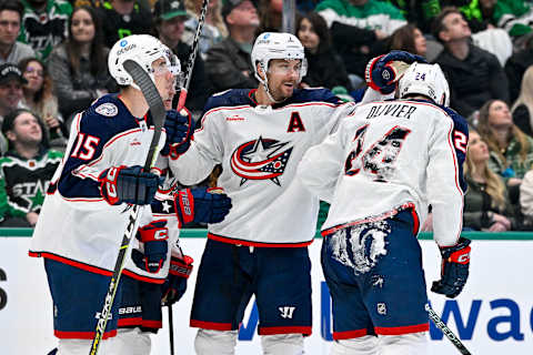 Feb 18, 2023; Dallas, Texas, USA; Columbus Blue Jackets defenseman Gavin Bayreuther (15) and center Sean Kuraly (7) and right wing Mathieu Olivier (24) skate off the ice after scoring a goal against the Dallas Stars during the third period at the American Airlines Center. Mandatory Credit: Jerome Miron-USA TODAY Sports