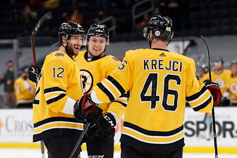 BOSTON, MASSACHUSETTS – APRIL 15: Crag Smith #12 of the Boston Bruins celebrates with Davi Krejci #46 and Charle McAvoy #73 after scoring a goal against the New York Islanders during the first period at TD Garden on April 15, 2021, in Boston, Massachusetts. (Photo by Maddie Meyer/Getty Images)