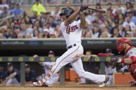 Jun 21, 2016; Minneapolis, MN, USA; Minnesota Twins center fielder Byron Buxton (25) hits a RBI sacrifice fly in the third inning against the Philadelphia Phillies at Target Field. Mandatory Credit: Jesse Johnson-USA TODAY Sports