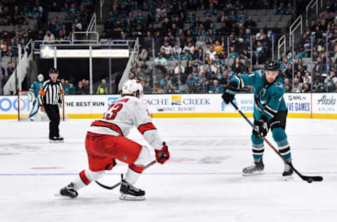 SAN JOSE, CA – OCTOBER 16: Brenden Dillon #4 of the San Jose Sharks passes the puck ahead against the Carolina Hurricanes at SAP Center on October 16, 2019 in San Jose, California. (Photo by Brandon Magnus/NHLI via Getty Images)