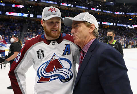 MacKinnon #29 of the Colorado Avalanche and Joe Sakic chat following the series winning victory over the Tampa Bay Lightning in Game Six of the 2022 NHL Stanley Cup Final at Amalie Arena on June 26, 2022 in Tampa, Florida. (Photo by Bruce Bennett/Getty Images)