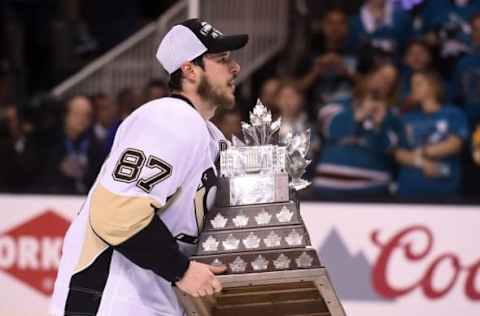 Jun 12, 2016; San Jose, CA, USA; Pittsburgh Penguins center Sidney Crosby (87) skates with the Conn Smythe Trophy after defeating the San Jose Sharks in game six of the 2016 Stanley Cup Final at SAP Center at San Jose. Mandatory Credit: Gary A. Vasquez-USA TODAY Sports