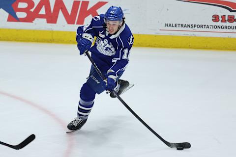 SYRACUSE, NY – APRIL 21: Alex Barré-Boulet #12 of Syracuse Crunch passes the puck against the Rochester Americans at Upstate Medical University Arena on April 21, 2023 in Syracuse, New York. (Photo by Isaiah Vazquez/Getty Images)