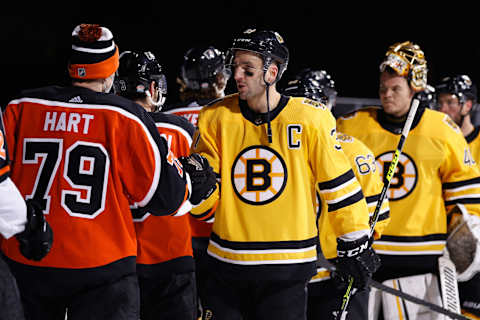 Patrice Bergeron fist bumps with Carter Hart after defeating the Flyers in the ‘NHL Outdoors At Lake Tahoe’ game. (Photo by Christian Petersen/Getty Images)