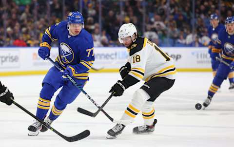 Mar 19, 2023; Buffalo, New York, USA; Buffalo Sabres right wing JJ Peterka (77) makes a pass as Boston Bruins center Pavel Zacha (18) defends during the second period at KeyBank Center. Mandatory Credit: Timothy T. Ludwig-USA TODAY Sports