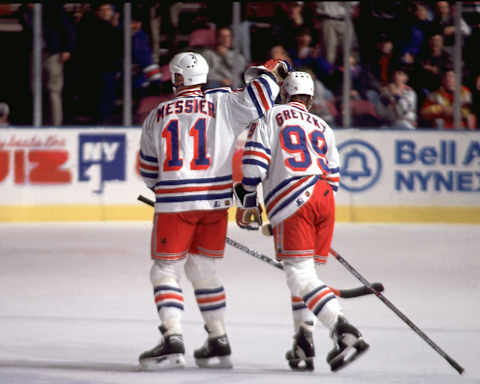 2000 Season: Gretzky and Messier celebrate And Player Wayne Gretzky. (Photo by Bruce Bennett Studios/Getty Images)