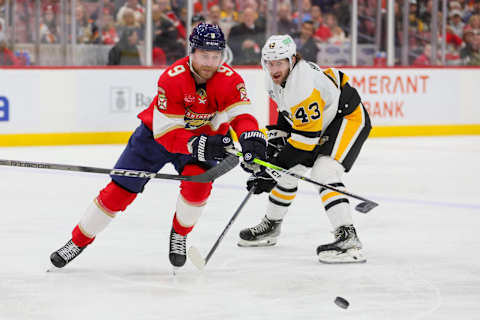 Dec 8, 2023; Sunrise, Florida, USA; Florida Panthers center Sam Bennett (9) protects the puck from Pittsburgh Penguins center Jansen Harkins (43) during the second period at Amerant Bank Arena. Mandatory Credit: Sam Navarro-USA TODAY Sports