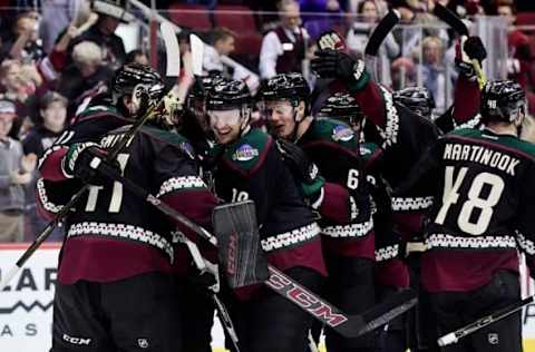 Nov 25, 2016; Glendale, AZ, USA; Arizona Coyotes goalie Mike Smith (41) and right wing Shane Doan (19) celebrate with teammates after beating the Edmonton Oilers 3-2 in a shootout at Gila River Arena. Mandatory Credit: Matt Kartozian-USA TODAY Sports