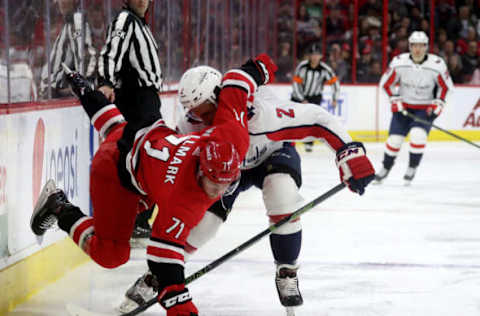 RALEIGH, NC – MARCH 28: Lucas Wallmark #71 of the Carolina Hurricanes is upended by Matt Niskanen #2 of the Washington Capitals during an NHL game on March 28, 2019 at PNC Arena in Raleigh, North Carolina. (Photo by Gregg Forwerck/NHLI via Getty Images)