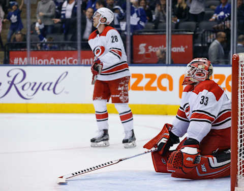 TORONTO, ON – DECEMBER 19: Carolina Hurricanes goalie Scott Darling (33) and Carolina Hurricanes center Elias Lindholm (28) look to the replay after the 8th goal is scored. Toronto Maple Leafs VS Carolina Hurricanes during 3rd period action in NHL regular season play at the Air Canada Centre. Leafs won 8-1. Toronto Star/Rick Madonik (Rick Madonik/Toronto Star via Getty Images)