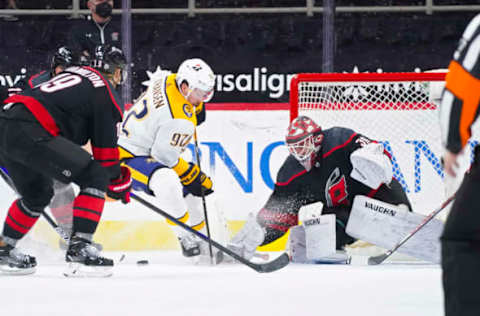 Mar 9, 2021; Raleigh, North Carolina, USA; Carolina Hurricanes goaltender Alex Nedeljkovic (39) stops the overtime shot of Nashville Predators center Ryan Johansen (92) at PNC Arena. Mandatory Credit: James Guillory-USA TODAY Sports