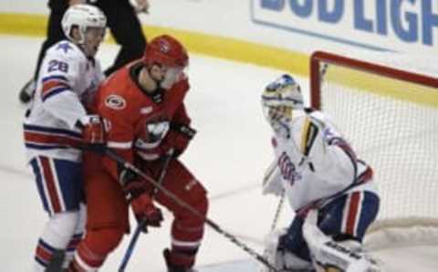 Rochester Americans goalie Scott Wedgewood, right, and defenseman Lawrence Pilut, left, defend against a shot by Charlotte Checkers right wing Julien Gauthier.Roc 100518 Amerks Opener A