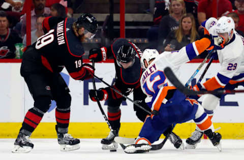 RALEIGH, NC – May 1: Carolina Hurricanes’ Dougie Hamilton #19 and Lucas Wallmark #71 of the Carolina Hurricanes battle Josh Bailey #12 of the New York Islanders in Game Three of the Eastern Conference Second Round during the 2019 NHL Stanley Cup Playoffs at PNC Arena on May 1, 2019, in Raleigh, North Carolina. (Photo by Karl DeBlaker/NHLI via Getty Images)