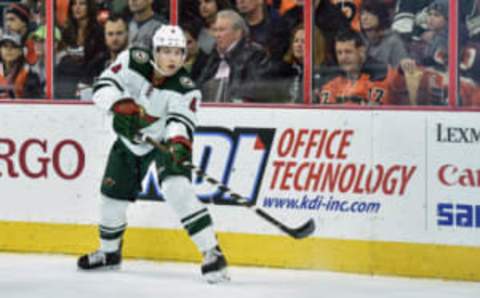 Nov 12, 2016; Philadelphia, PA, USA; Minnesota Wild defenseman Mike Reilly (4) passes during the second period of the game against the Philadelphia Flyers at the Wells Fargo Center. The flyers won the game 3-2. Mandatory Credit: John Geliebter-USA TODAY Sports