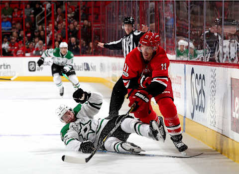 RALEIGH, NC – NOVEMBER 13: Esa Lindell #23 of the Dallas Stars attempts to break up a pass that leads to an assist on a goal by Jordan Staal #11 of the Carolina Hurricanes during an NHL game on November 13, 2017 at PNC Arena in Raleigh, North Carolina. (Photo by Gregg Forwerck/NHLI via Getty Images)