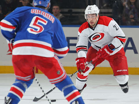 NEW YORK, NY – DECEMBER 21: Justin Faulk #27 of the Carolina Hurricanes skates with the puck against Dan Girardi #5 of the New York Rangers at Madison Square Garden on December 21, 2014 in New York City. The New York Rangers won 1-0. (Photo by Jared Silber/NHLI via Getty Images)