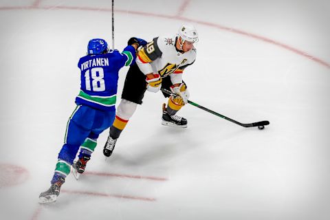 Vancouver Canucks right wing Jake Virtanen (18) and Vegas Golden Knights right wing Reilly Smith (19) fight for the puck. Mandatory Credit: Perry Nelson-USA TODAY Sports