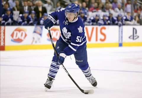 Dec 5, 2013; Toronto, Ontario, CAN; Toronto Maple Leafs defenseman Jake Gardiner (51) shoots against the Dallas Stars at Air Canada Centre. The Maple Leafs beat the Stars 3-2 in overtime. Mandatory Credit: Tom Szczerbowski-USA TODAY Sports