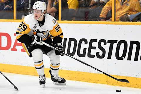 Jun 5, 2017; Nashville, TN, USA; Pittsburgh Penguins center Jake Guentzel (59) controls the puck against the Nashville Predators in the third period in game four of the 2017 Stanley Cup Final at Bridgestone Arena. Mandatory Credit: Christopher Hanewinckel-USA TODAY Sports