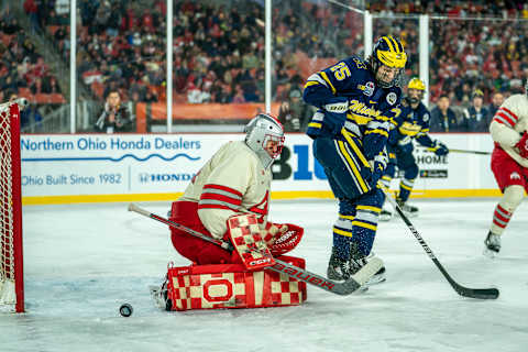 CLEVELAND, OH FEBRUARY 18: Jakub Dobes #44 of the Ohio State Buckeyes makes the save with pressure from Dylan Duke #25 of the Michigan Wolverines during the 3rd period of the Faceoff on the Lake NCAA ice hockey game at FirstEnergy Stadium on February 18, 2023 in Cleveland, OH. Ohio State won the game with a final score of 4-2. (Photo by Jaime Crawford/Getty Images)