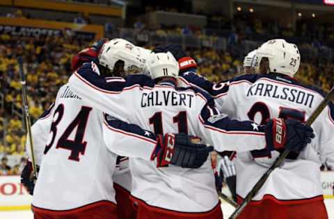 Apr 12, 2017; Pittsburgh, PA, USA; Columbus Blue Jackets left wing Matt Calvert (11) celebrates with teammates after scoring a goal against the Pittsburgh Penguins during the third period in game one of the first round of the 2017 Stanley Cup Playoffs at PPG PAINTS Arena. The Penguins won 3-1. Mandatory Credit: Charles LeClaire-USA TODAY Sports