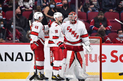 MONTREAL, QC – OCTOBER 21: (L-R) Jordan Martinook #48, Derek Stepan #18, and goaltender Frederik Andersen #31 of the Carolina Hurricanes celebrate their victory against the Montreal Canadiens at Centre Bell on October 21, 2021, in Montreal, Canada. The Carolina Hurricanes defeated the Montreal Canadiens 4-1. (Photo by Minas Panagiotakis/Getty Images)