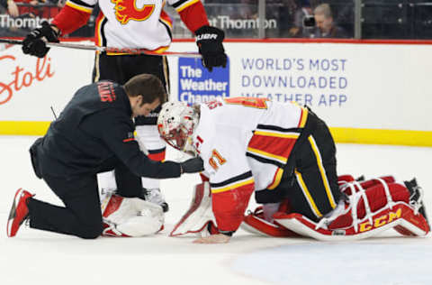 NEW YORK, NY – FEBRUARY 11: A trainer tends to Mike Smith #41 of the Calgary Flames during the final moments of a 3-2 win against the New York Islanders at Barclays Center on February 11, 2018 in the Brooklyn borough of New York City. (Photo by Paul Bereswill/NHLI via Getty Images)