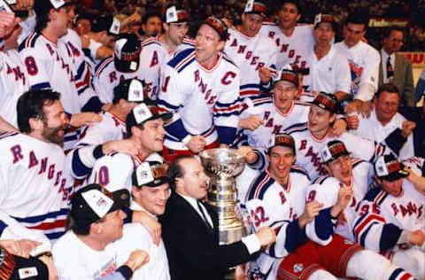 NEW YORK, NY – JUNE 14: Mark Messier #11 and head coach Mike Keenan of the New York Rangers get ready for the Stanley Cup team picture after the Rangers defeated the Vancouver Canucks in Game 7 of the 1994 Stanley Cup Finals on June 14, 1994 at the Madison Square Garden in New York, New York. The Rangers defeated the Canucks 3-2 and won the series 4-3. (Photo by Steve Babineau/NHLI via Getty Images)