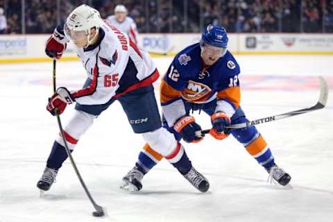 Feb 18, 2016; Brooklyn, NY, USA; Washington Capitals left wing Andre Burakovsky (65) shoots in front of New York Islanders left wing Josh Bailey (12) during the first period at Barclays Center. Mandatory Credit: Brad Penner-USA TODAY Sports