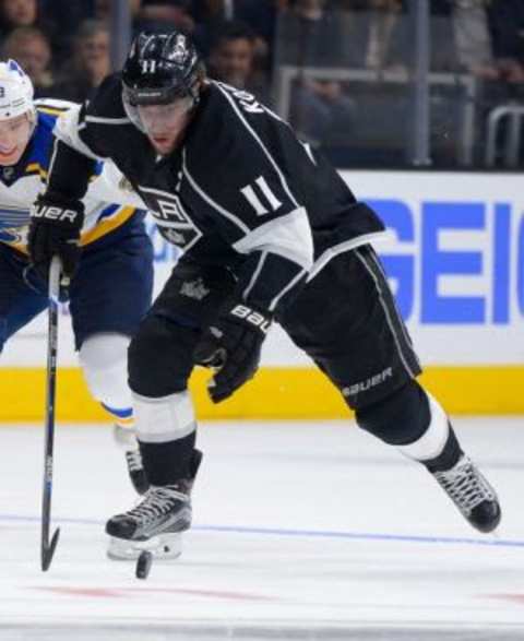 Jan 9, 2016; Los Angeles, CA, USA; Los Angeles Kings center Anze Kopitar (11) skates with the puck as St. Louis Blues right wing Dmitrij Jaskin (23) chases in the second period of the game at Staples Center. Mandatory Credit: Jayne Kamin-Oncea-USA TODAY Sports