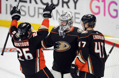 ANAHEIM, CA: Anaheim Ducks goalie John Gibson (36) celebrates his 4-0 shutout over Washington with defenseman Brandon Montour (26) and defenseman Hampus Lindholm (47). (Photo by John Cordes/Icon Sportswire via Getty Images)